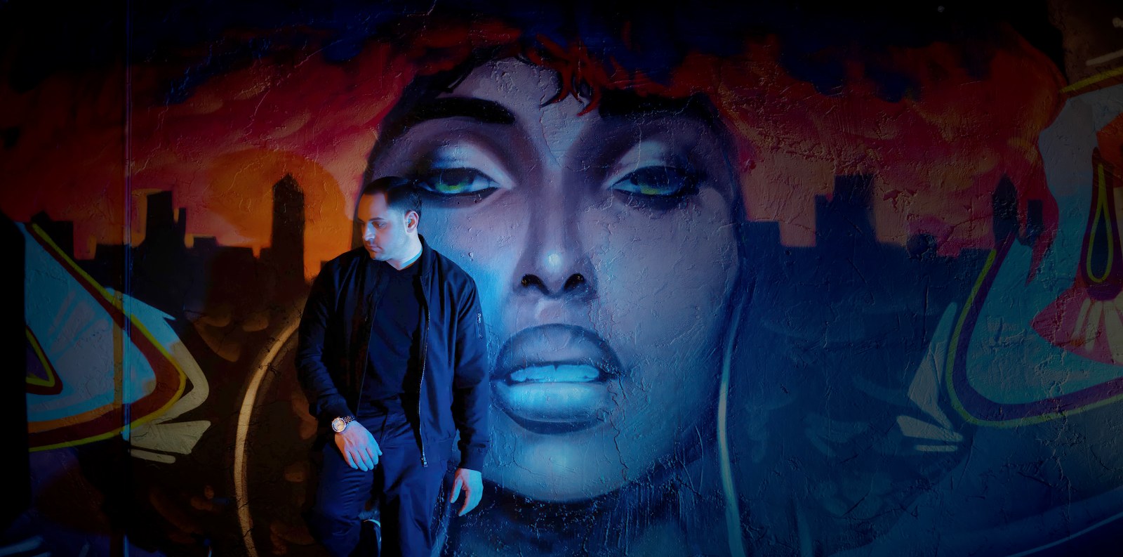 Anelo Pontecorvo in front of mural